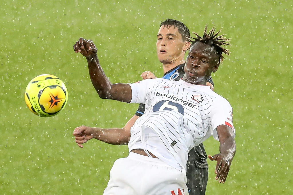 L'attaquant de Lille Usman Simbakoli devant le défenseur de Bruges Federico Ricca en match amical