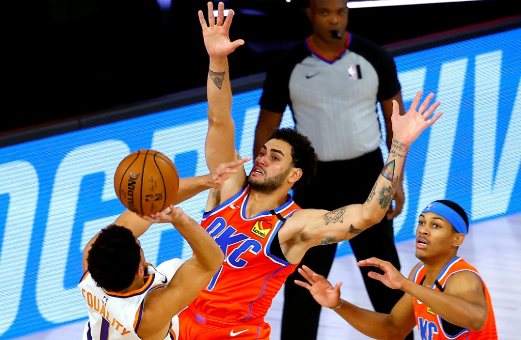 Oklahoma City's Abdel Nader defends against Phoenix's Devin Booker during the Thunder's defeat on Monday