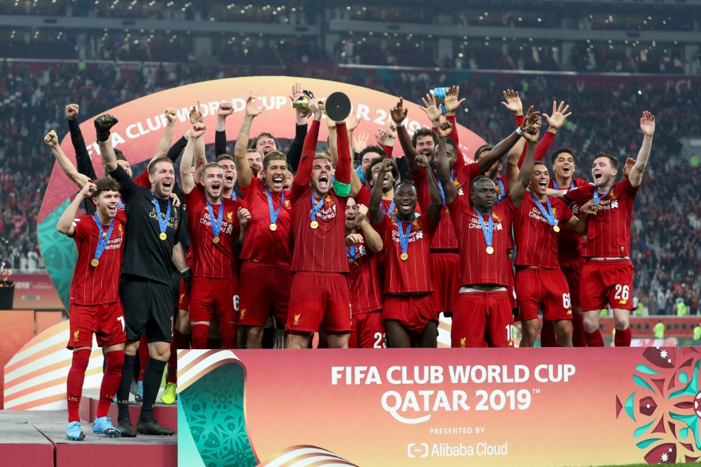 Liverpool's players lift the trophy following the 2019 FIFA Club World Cup Final football match between England's Liverpool and Brazil's Flamengo at the Khalifa International Stadium in the Qatari capital Doha on December 21
