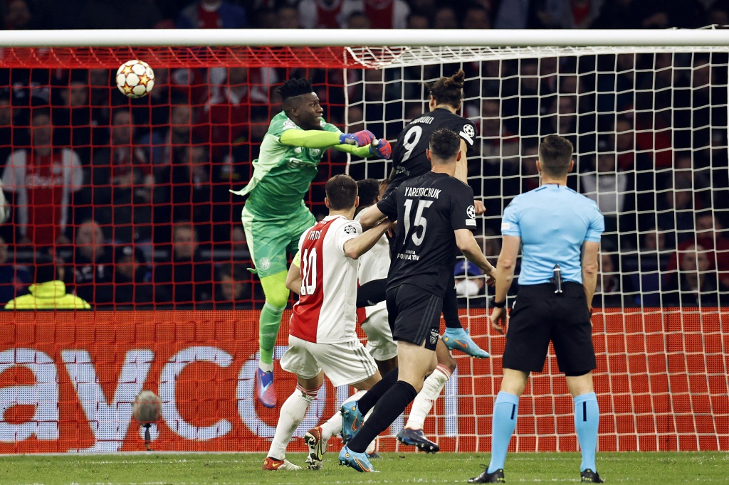 L'attaquant uruguayen de Benfica Darwin Nunez devance le gardien camerounais de l'Ajax Amsterdam Andre Onana et marque, lors du 8e de finale retour de la Ligue des Champions, le 15 mars 2022 à la Johan Cruyff ArenA