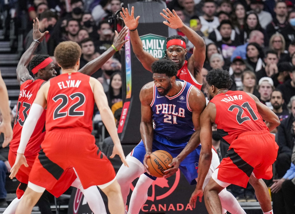 Le Camerounais Joel Embiid (Philadelphia 76ers), pris en tenaille par les défenseurs des Toronto Raptors, lors de leur match de NBA, le 7 avril 2022 au Canada