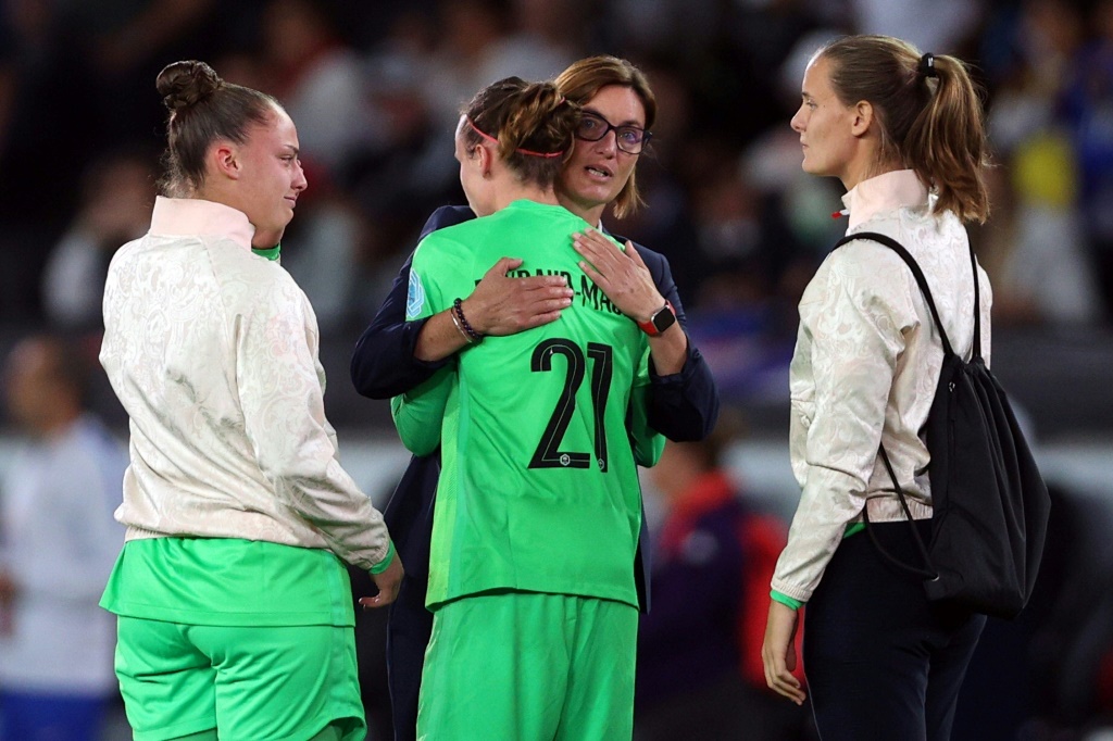 La sélectionneuse des Bleues Corinne Diacre réconforte la gardienne Pauline Peyraud-Magnin, après la défaite en demi-finale de l'Euro face à l'Allemagne, le 27 juillet 2022 à Milton Keynes