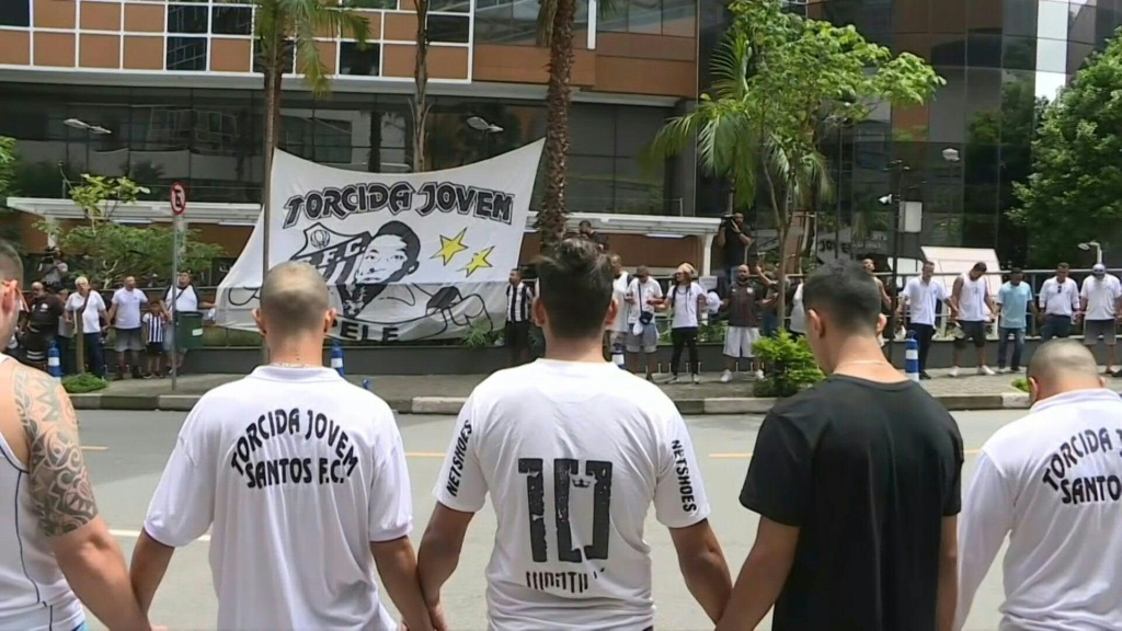 Des fans du club de football Santos installent un drapeau avec le portrait du Brésilien Pelé devant l'hôpital Albert-Einstein où il est soigné pour une infection pulmonaire