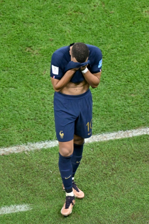 L'attaquant français Kylian Mbappé la tête dans les mains après la défaite contre l'Argentine en finale de la Coupe du monde au Qatar