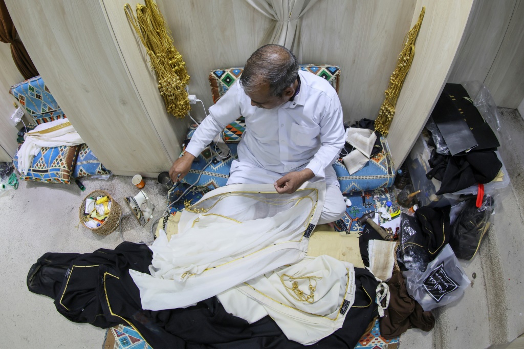 Un employé s'applique à la fabrication d'un manteau traditionnel qatari ("bisht") dans le souk Waqif de Doha