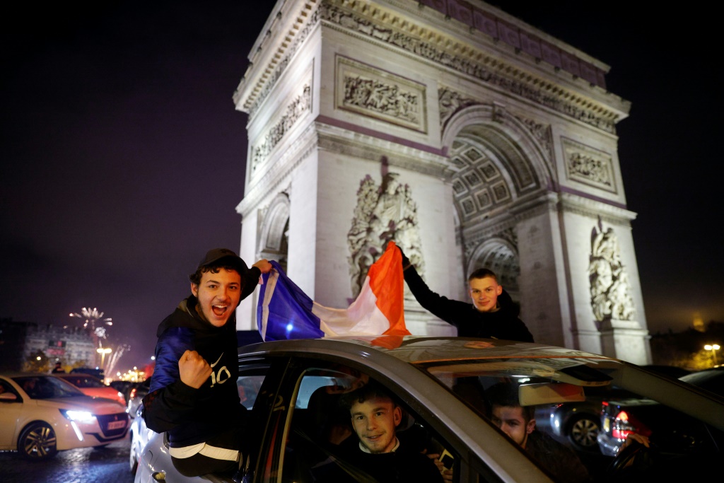 Des supporters français célèbrent la victoire de la France face à l'Angleterre en quart de finale de la Coupe du monde au Qatar