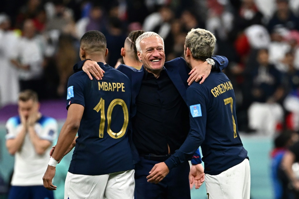 Le sélectionneur français Didier Deschamps félicite Kylian Mbappé et Antoine Griezmann après la victoire contre l'Angleterre en quart de finale du Mondial