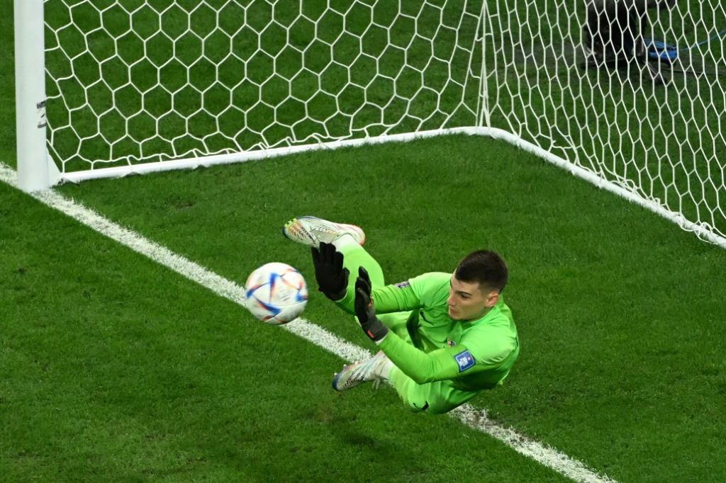 Le gardien croate Dominik Livakovic repousse le tir au but du Brésilien Rodrygo lors du quart de finale du Mondial le 9 décembre 2022 à Doha