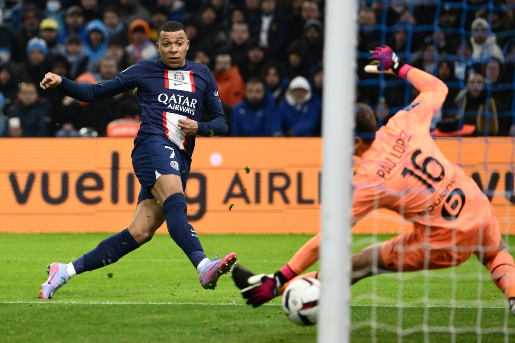 Kylian Mbappé marque son deuxième but pour Paris face au gardien de l'OM Pau Lopez (d)