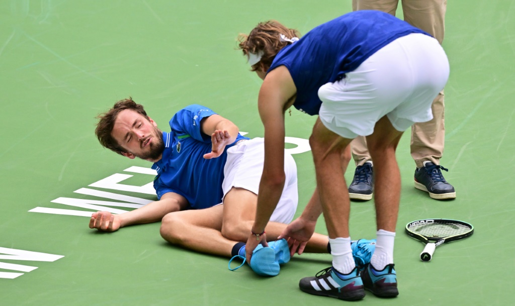 Le Russe Daniil Medvedev réagit quand l'Allemand Alexander Zverev lui touche le pied après une chute lors d'un match de  tennis à Indian Wells le 14 mars 2023