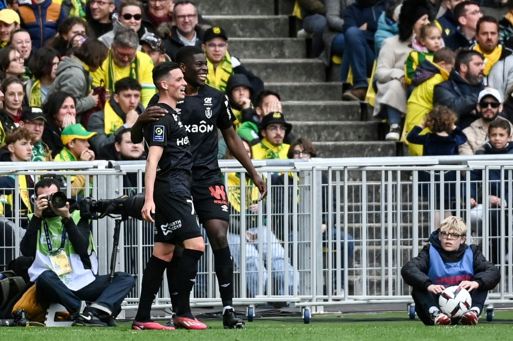 Le milieu de terrain du Stade de Reims, Alexis Flips (G), célèbre son double sur le terrain du FC Nantes, en Ligue 1, le 2 avril 2023